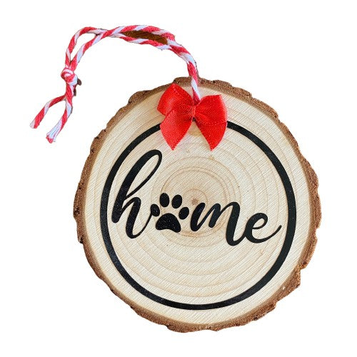 Close up of the "Home is Where the Paws Are" wooden decoration in the Fur Baby gift basket 