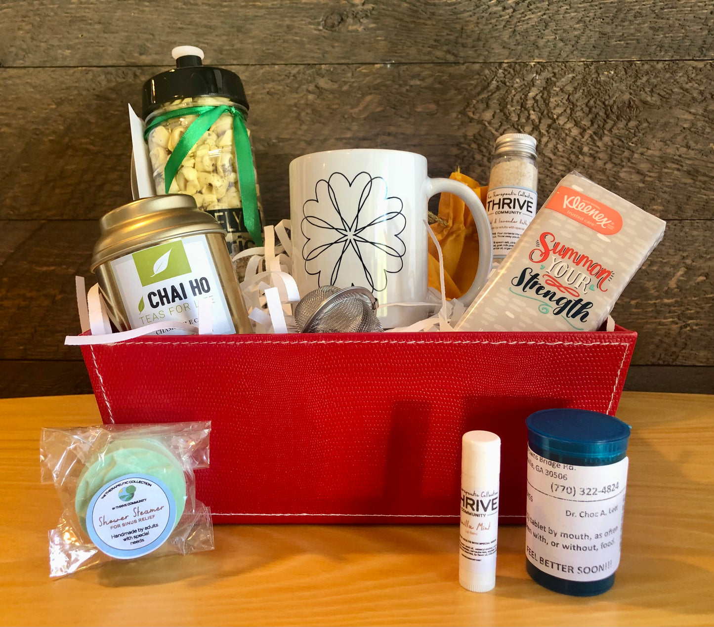 Gift basket for someone under the weather with a mug, tea, tissues,  lip balm, shower steamer, soup and chocolate treats