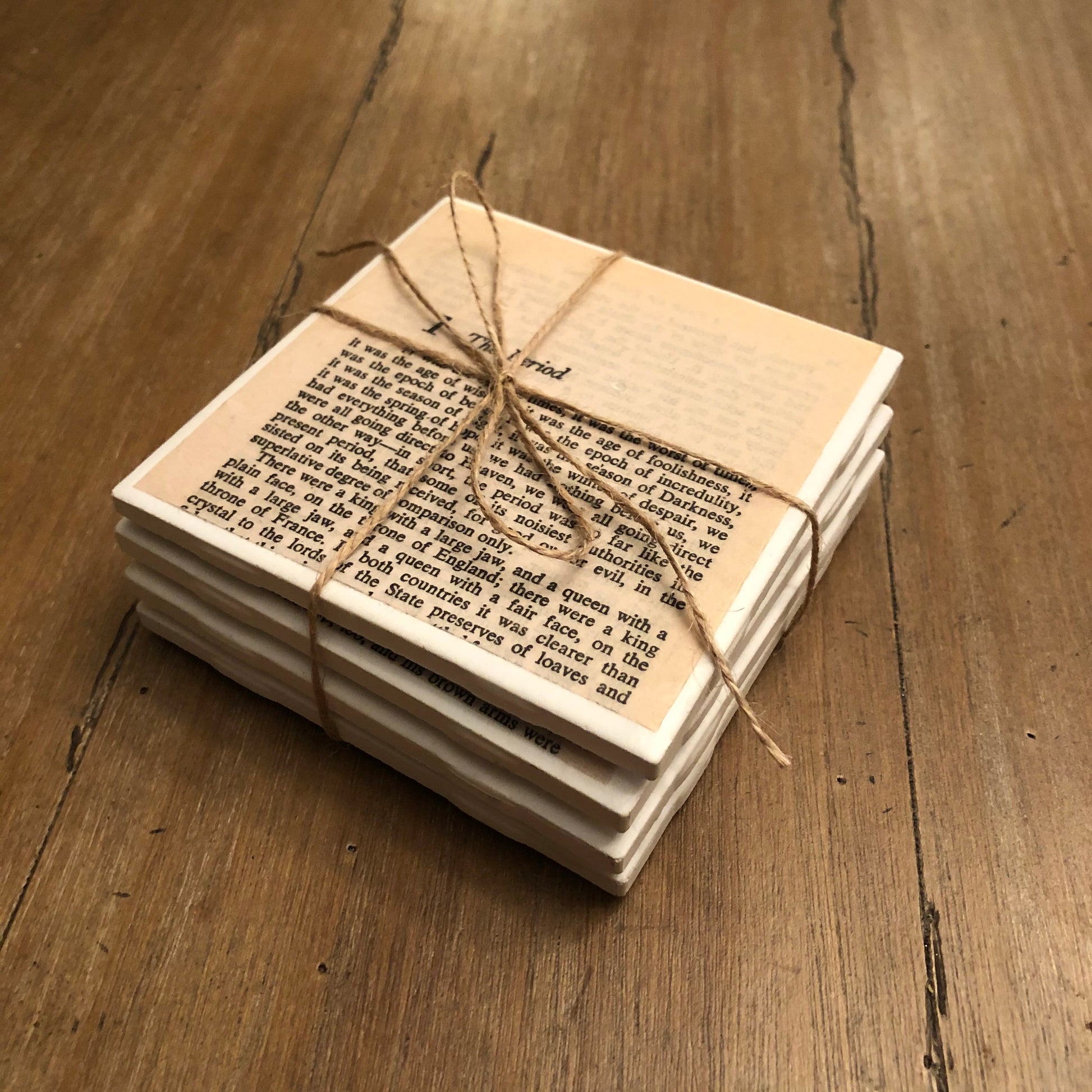 coasters featuring printed pages of classic novels with cork backing