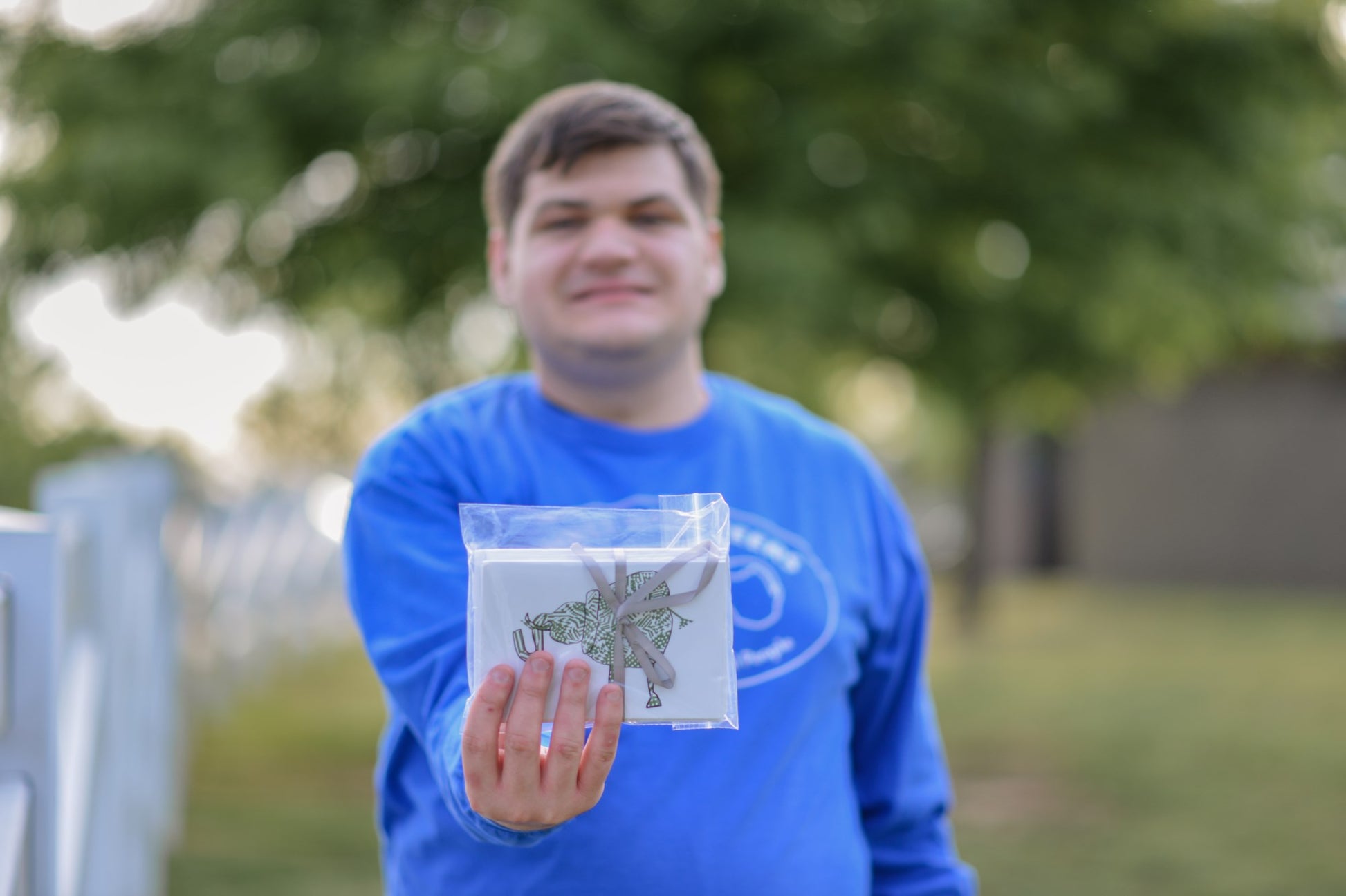 Basketeer Luke holding package of elephant notecards